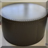 F13. Round leather ottoman with nailhead trim 19”h x 34”w 